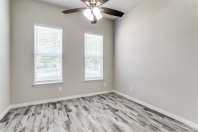 7711 Heather Ridge Ct, Irving, TX 75063 - spare room with light wood-style flooring, a ceiling fan, and baseboards
