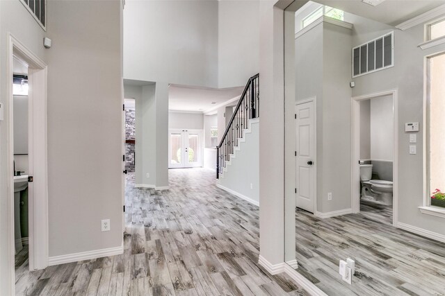 7711 Heather Ridge Ct, Irving, TX 75063 - foyer entrance with a high ceiling, wood finished floors, plenty of natural light, and stairs
