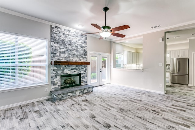 7711 Heather Ridge Ct, Irving, TX 75063 - unfurnished living room with ceiling fan, plenty of natural light, light wood-style floors, and crown molding