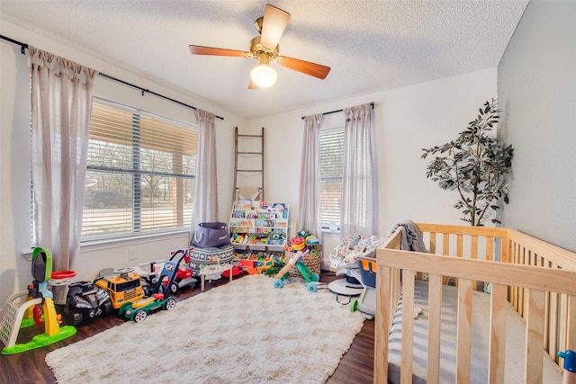 1187 Timber Creek Cir, Kaufman, TX 75142 - bedroom featuring wood finished floors, a ceiling fan, and a textured ceiling