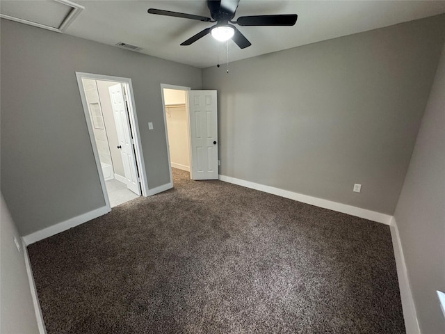 6832 Brierfield Cir, Dallas, TX 75232 - unfurnished bedroom with a spacious closet, carpet floors, ensuite bath, baseboards, and a ceiling fan