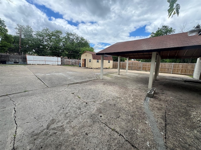 6832 Brierfield Cir, Dallas, TX 75232 - view of patio featuring fence, a storage shed, and an outdoor structure