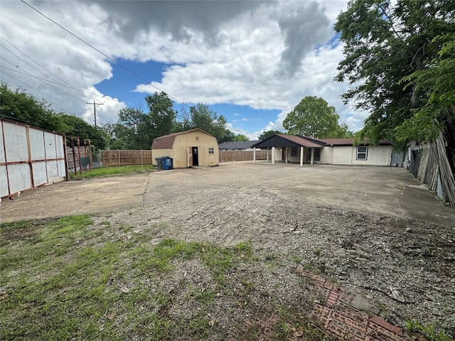 6832 Brierfield Cir, Dallas, TX 75232 - view of yard with fence, a storage unit, and an outdoor structure