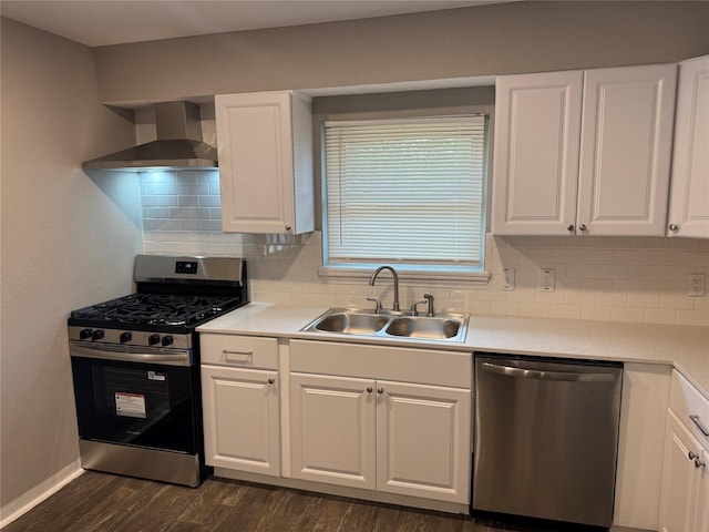 6832 Brierfield Cir, Dallas, TX 75232 - kitchen featuring appliances with stainless steel finishes, wall chimney range hood, a sink, and white cabinetry
