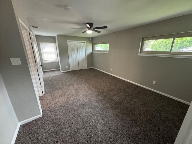 6832 Brierfield Cir, Dallas, TX 75232 - unfurnished bedroom with dark carpet, baseboards, a closet, and a ceiling fan