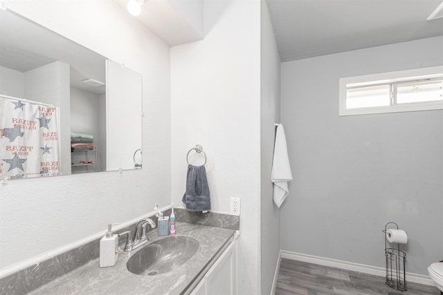 7662 Vz County Road 3504, Wills Point, TX 75169 - bathroom with wood finished floors, vanity, toilet, and baseboards