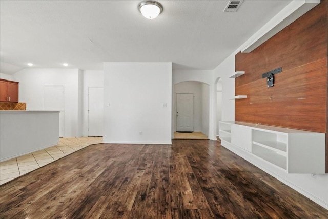 8410 Sussex St, White Settlement, TX 76108 - unfurnished living room with arched walkways, wood finished floors, and recessed lighting