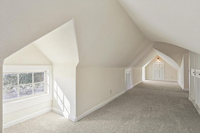 4532 Calmont Ave, Fort Worth, TX 76107 - additional living space featuring vaulted ceiling, carpet flooring, a textured ceiling, and baseboards