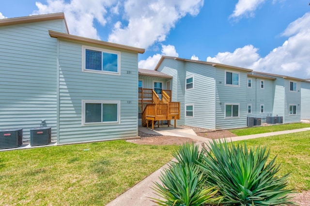 230 Cut Off Rd Unit 231, Port Aransas, TX 78373 - back of property featuring central air condition unit, a yard, and a deck