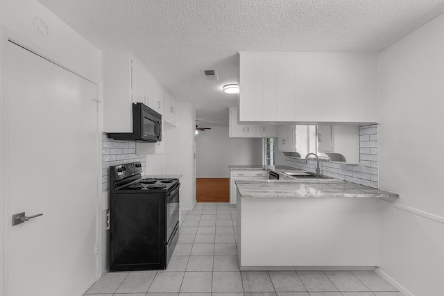 6032 Highcrest Dr, Watauga, TX 76148 - kitchen with black appliances, a peninsula, a sink, a textured ceiling, and tasteful backsplash