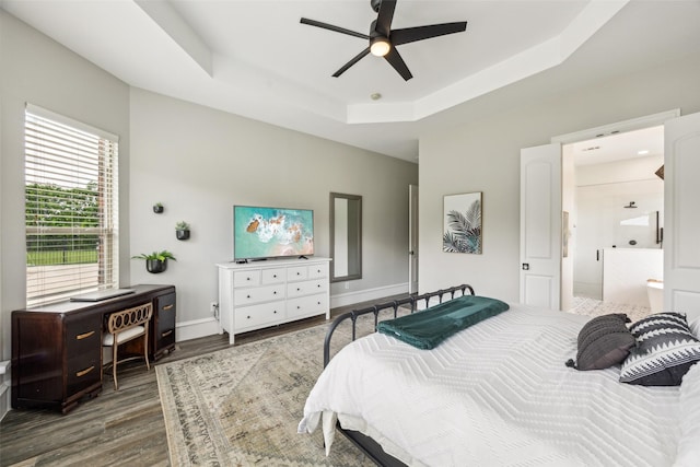 5900 Stage Coach Cir, Westlake, TX 76262 - bedroom with wood finished floors, a raised ceiling, baseboards, ensuite bathroom, and ceiling fan