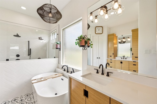 5900 Stage Coach Cir, Westlake, TX 76262 - bathroom featuring a walk in shower, a freestanding tub, two vanities, and a chandelier