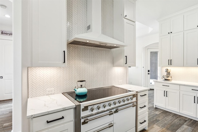 5900 Stage Coach Cir, Westlake, TX 76262 - kitchen featuring wall chimney exhaust hood, high end range, backsplash, dark wood-type flooring, and white cabinets