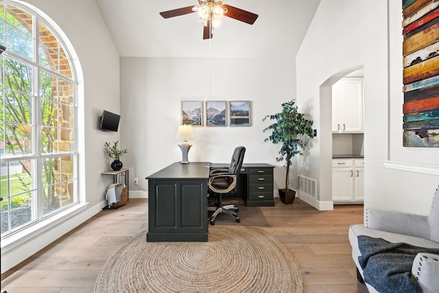 2441 Deerwood Dr, Little Elm, TX 75068 - office with a ceiling fan, light wood-type flooring, high vaulted ceiling, arched walkways, and baseboards