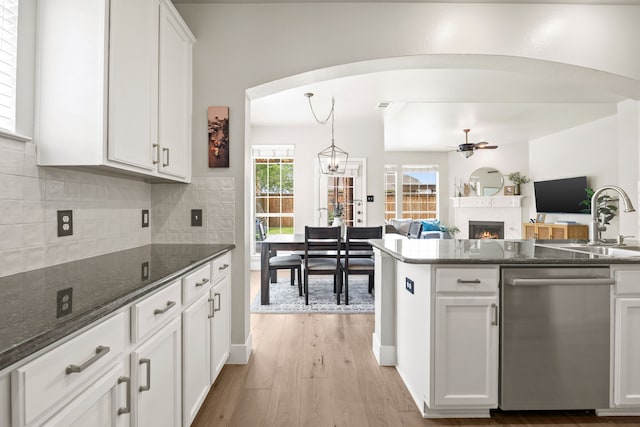 2441 Deerwood Dr, Little Elm, TX 75068 - kitchen with dishwasher, a sink, ceiling fan, white cabinetry, and decorative backsplash