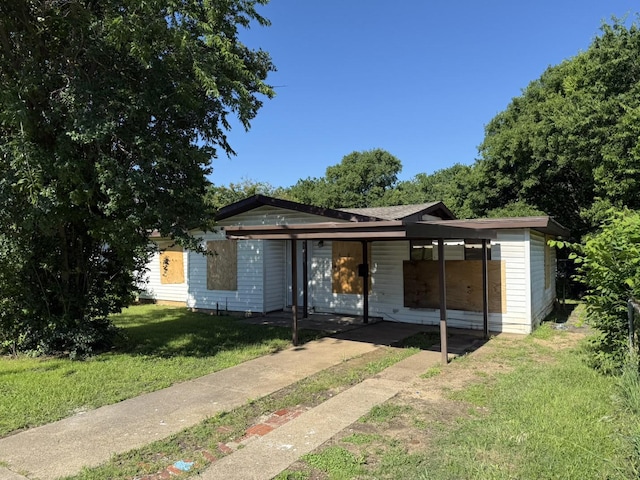3408 S Hughes Ave, Fort Worth, TX 76119 - view of front facade featuring a front lawn and an attached carport