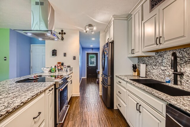 5225 Marks Cir, The Colony, TX 75056 - kitchen with appliances with stainless steel finishes, island range hood, a sink, decorative backsplash, and dark wood-style flooring