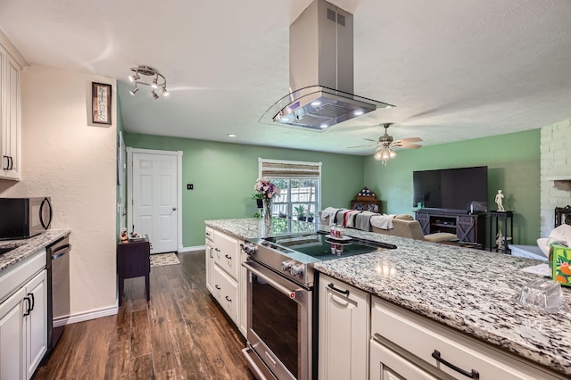 5225 Marks Cir, The Colony, TX 75056 - kitchen with stainless steel appliances, island exhaust hood, white cabinets, dark wood-style floors, and light stone countertops