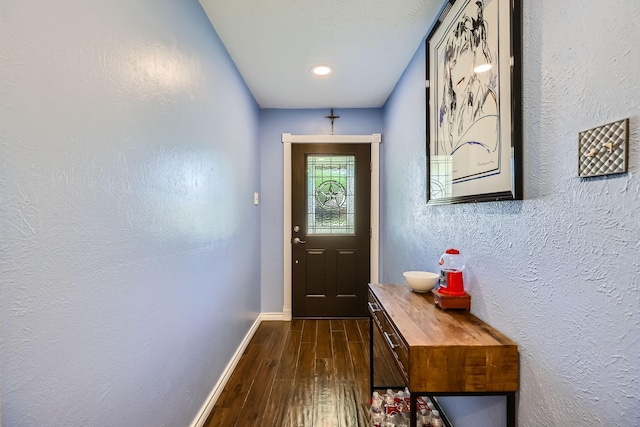 5225 Marks Cir, The Colony, TX 75056 - doorway featuring dark wood finished floors, a textured wall, and baseboards