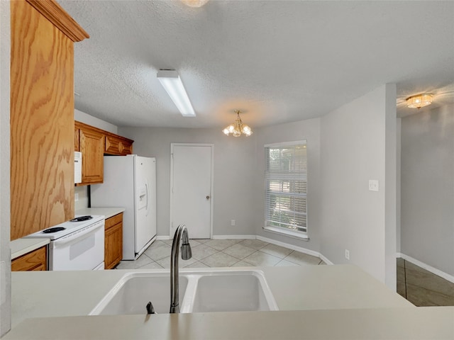1301 Archdale Ct, Fort Worth, TX 76028 - kitchen with white appliances, a sink, light tile patterned floors, light countertops, and brown cabinets