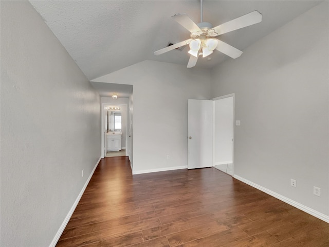 1301 Archdale Ct, Fort Worth, TX 76028 - spare room featuring a ceiling fan, dark wood-type flooring, vaulted ceiling, and baseboards