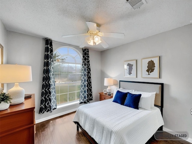 1301 Archdale Ct, Fort Worth, TX 76028 - bedroom with a textured ceiling, baseboards, ceiling fan, and wood finished floors