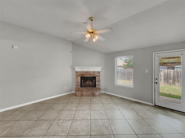 1301 Archdale Ct, Fort Worth, TX 76028 - unfurnished living room featuring vaulted ceiling, a ceiling fan, a brick fireplace, light tile patterned floors, and baseboards