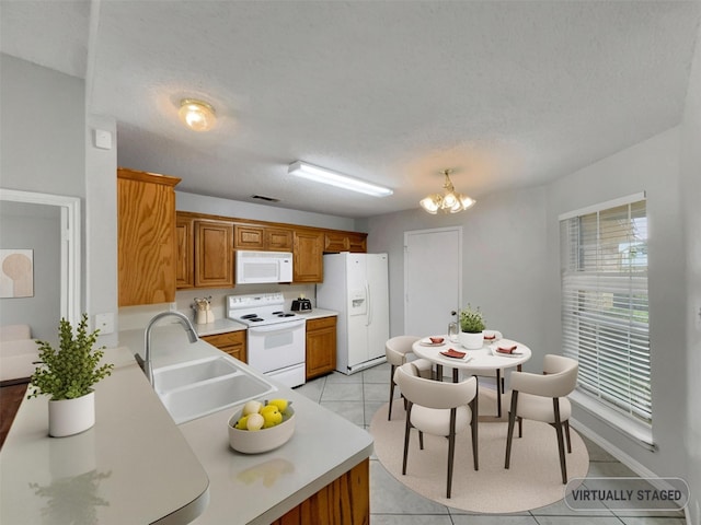 1301 Archdale Ct, Fort Worth, TX 76028 - kitchen featuring white appliances, a sink, light tile patterned floors, light countertops, and brown cabinetry