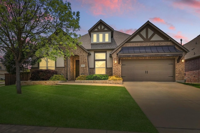 7401 Sabine Dr, Mckinney, TX 75071 - tudor-style house with brick siding, driveway, a yard, a shingled roof, and an attached garage