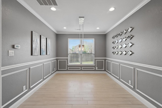 7401 Sabine Dr, Mckinney, TX 75071 - unfurnished dining area featuring crown molding, recessed lighting, light wood-type flooring, a decorative wall, and a chandelier
