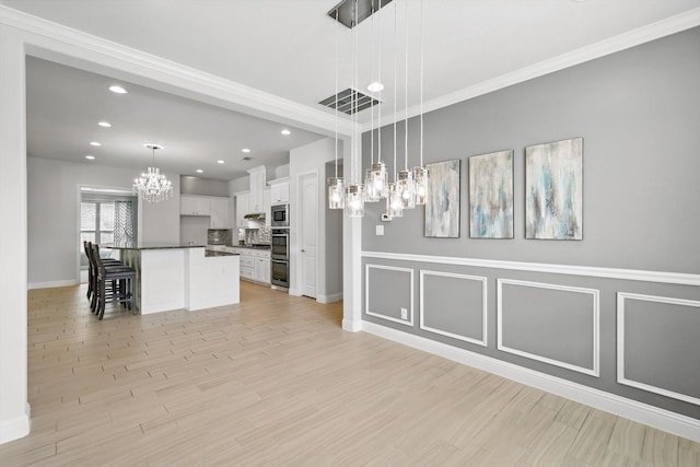 7401 Sabine Dr, Mckinney, TX 75071 - unfurnished dining area featuring a chandelier, recessed lighting, baseboards, light wood finished floors, and ornamental molding