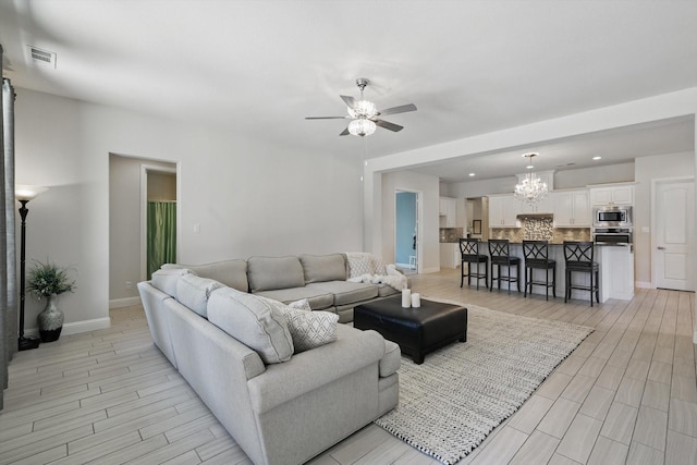 7401 Sabine Dr, Mckinney, TX 75071 - living room with ceiling fan, baseboards, a chandelier, wood tiled floors, and recessed lighting