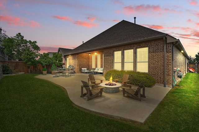 7401 Sabine Dr, Mckinney, TX 75071 - back of property at dusk featuring an outdoor fire pit, a patio, brick siding, and a shingled roof