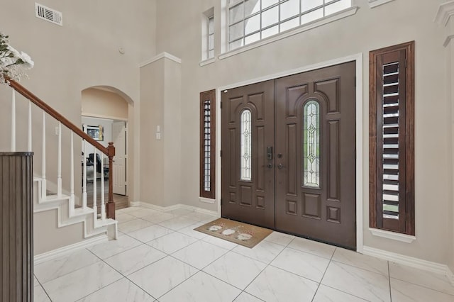 1925 Kiestwood Cir, Plano, TX 75025 - foyer featuring a high ceiling, healthy amount of natural light, arched walkways, baseboards, and stairs