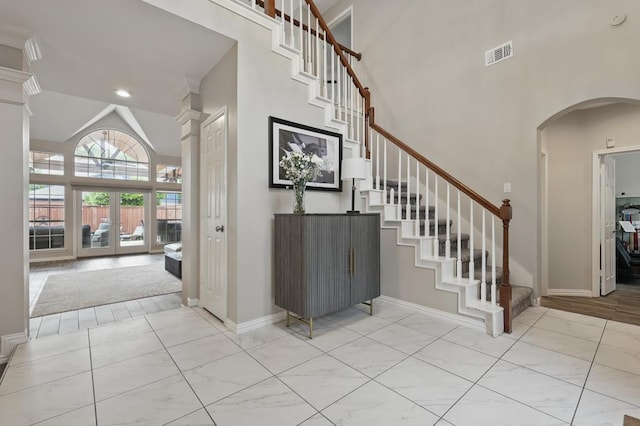 1925 Kiestwood Cir, Plano, TX 75025 - entryway with high vaulted ceiling, arched walkways, stairway, and baseboards