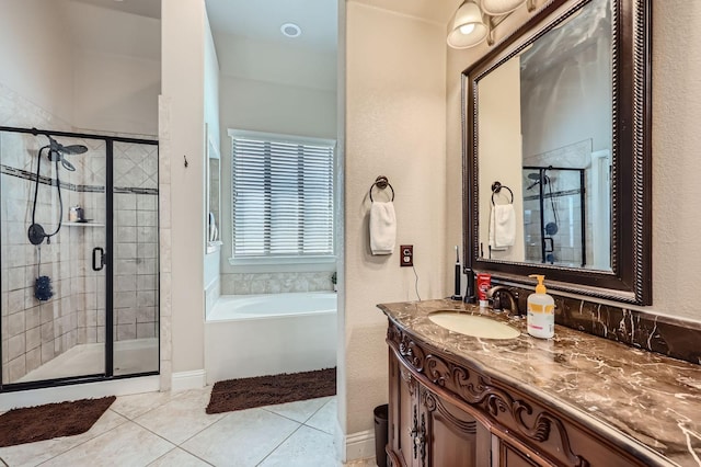 600 Oakmont Ct, Desoto, TX 75115 - bathroom featuring tile patterned floors, a stall shower, a garden tub, and vanity