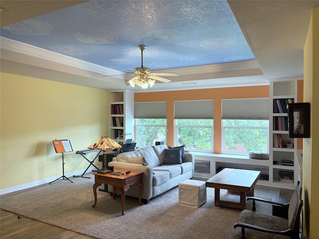 519 Butternut Dr, Garland, TX 75044 - living area with a tray ceiling, plenty of natural light, crown molding, a ceiling fan, and wood finished floors