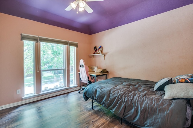 519 Butternut Dr, Garland, TX 75044 - bedroom with multiple windows, wood finished floors, ceiling fan, and vaulted ceiling