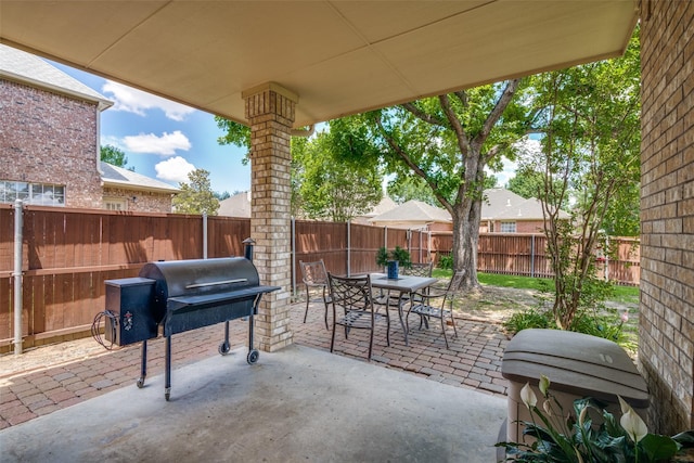 519 Butternut Dr, Garland, TX 75044 - view of patio / terrace with outdoor dining space, a fenced backyard, and grilling area