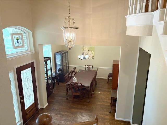 519 Butternut Dr, Garland, TX 75044 - dining space with a chandelier, wood finished floors, and a towering ceiling