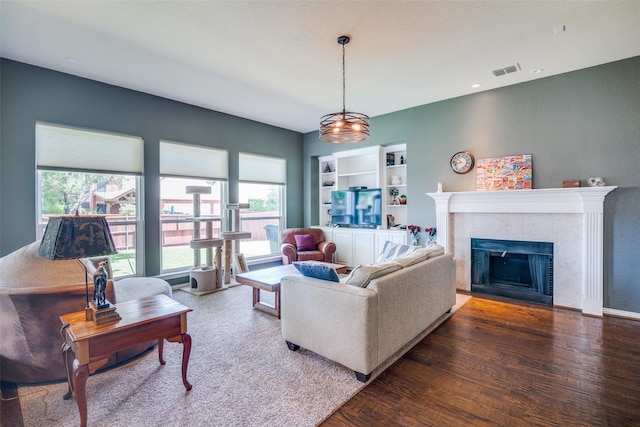 519 Butternut Dr, Garland, TX 75044 - living area featuring wood finished floors, plenty of natural light, and a fireplace