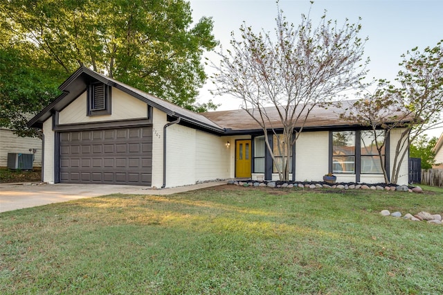 2702 Glen Ridge Dr, Arlington, TX 76016 - view of front of house featuring central AC, brick siding, a garage, concrete driveway, and a front yard