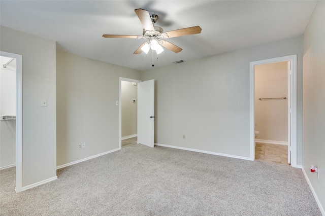 2702 Glen Ridge Dr, Arlington, TX 76016 - unfurnished bedroom with a walk in closet, carpet, a closet, ensuite bathroom, and baseboards