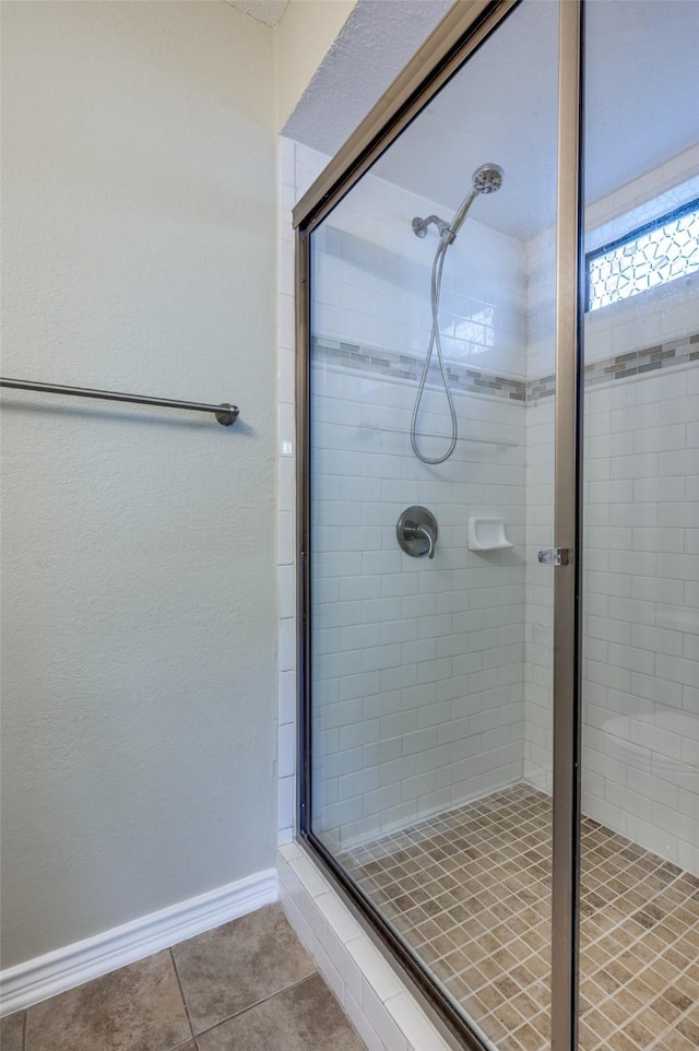 2702 Glen Ridge Dr, Arlington, TX 76016 - bathroom featuring a stall shower, tile patterned floors, and baseboards