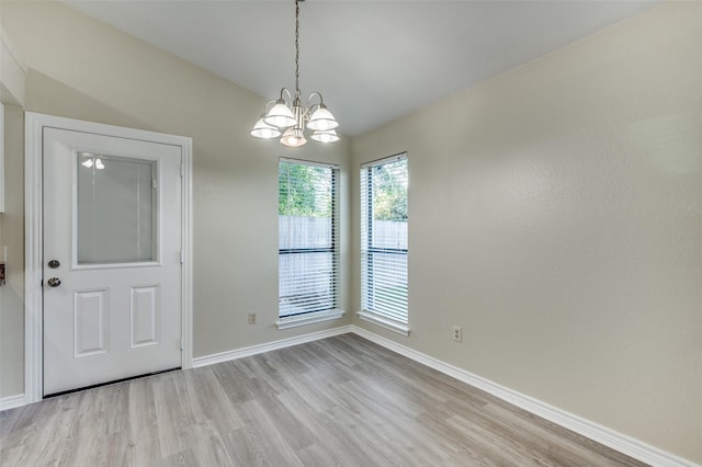 2702 Glen Ridge Dr, Arlington, TX 76016 - unfurnished dining area featuring light wood-style flooring and baseboards