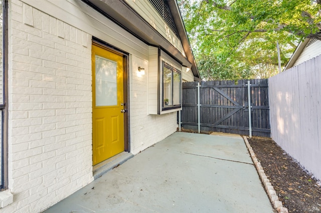 2702 Glen Ridge Dr, Arlington, TX 76016 - property entrance with brick siding, fence, a patio, and a gate