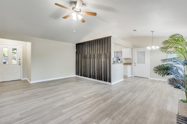 2702 Glen Ridge Dr, Arlington, TX 76016 - unfurnished living room with a chandelier, light wood-style floors, lofted ceiling, and ceiling fan