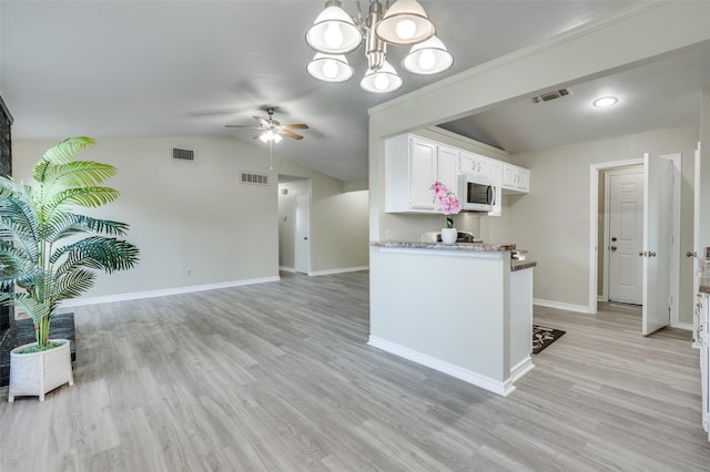 2702 Glen Ridge Dr, Arlington, TX 76016 - kitchen with white microwave, ceiling fan, white cabinetry, a chandelier, and baseboards