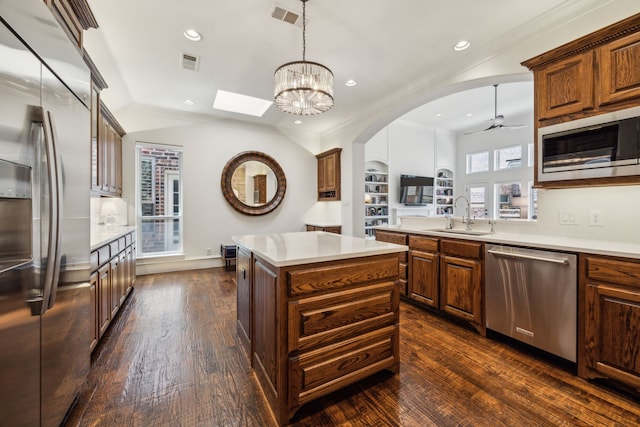 1675 Morris Ln, Frisco, TX 75034 - kitchen featuring built in appliances, a sink, a center island, dark wood-style floors, and light countertops
