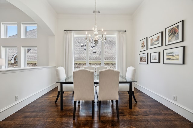 1675 Morris Ln, Frisco, TX 75034 - dining area featuring a chandelier, arched walkways, baseboards, and ornamental molding